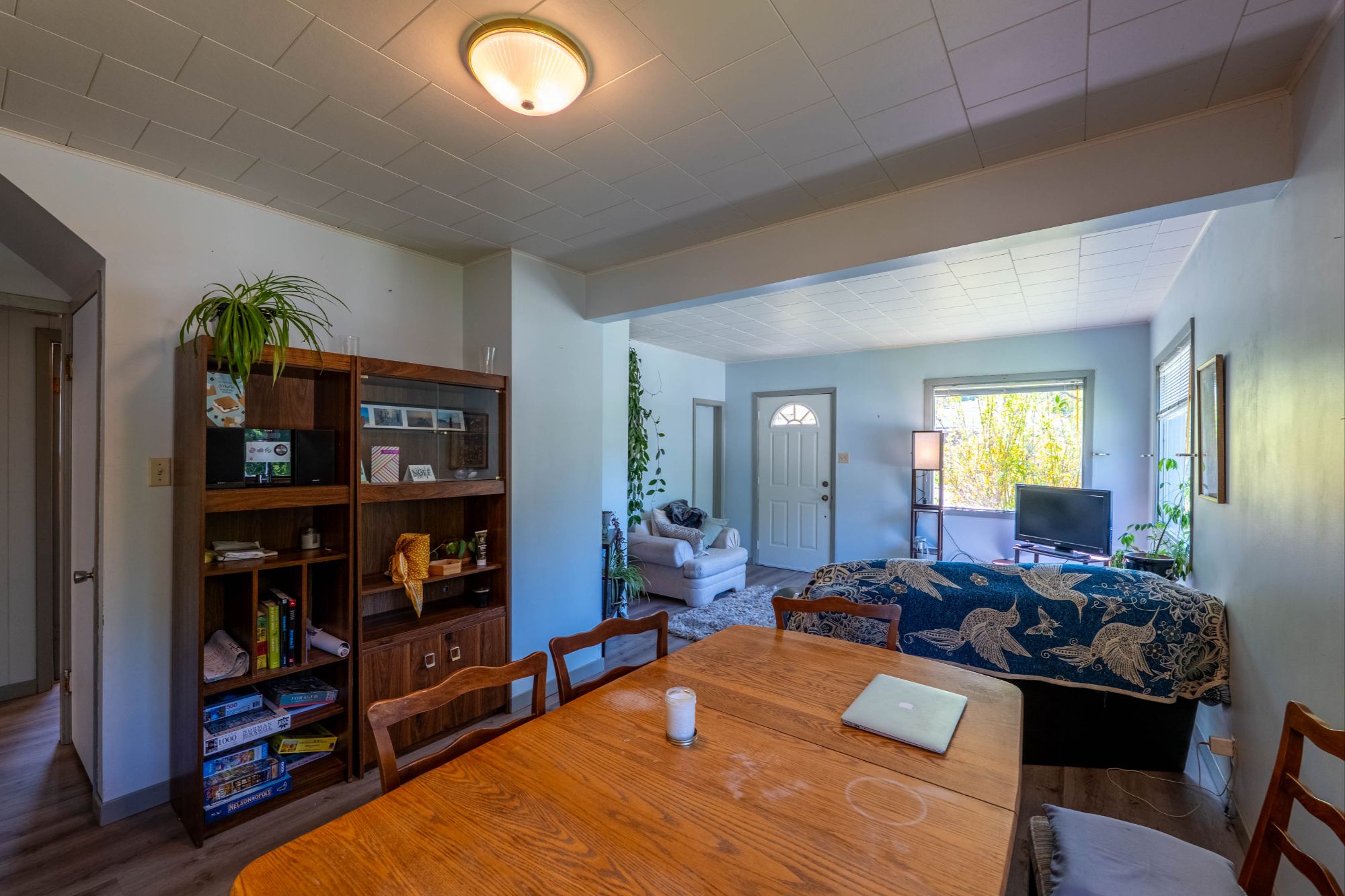 Bright and open living-dining area with natural light, cozy seating, and warm wood accents at 809 Davie Street, Nelson BC