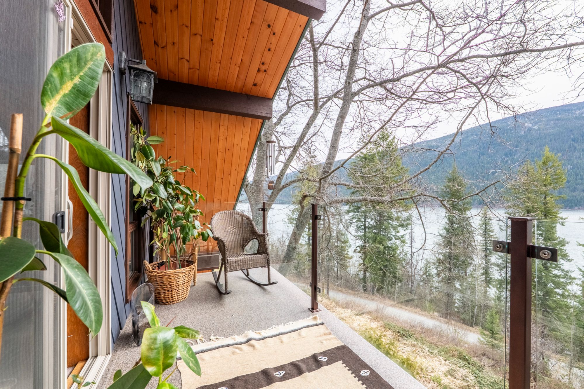 Covered balcony at 3169 Bainbridge Road in Nelson BC with lake and mountain views overlooking Kootenay Lake