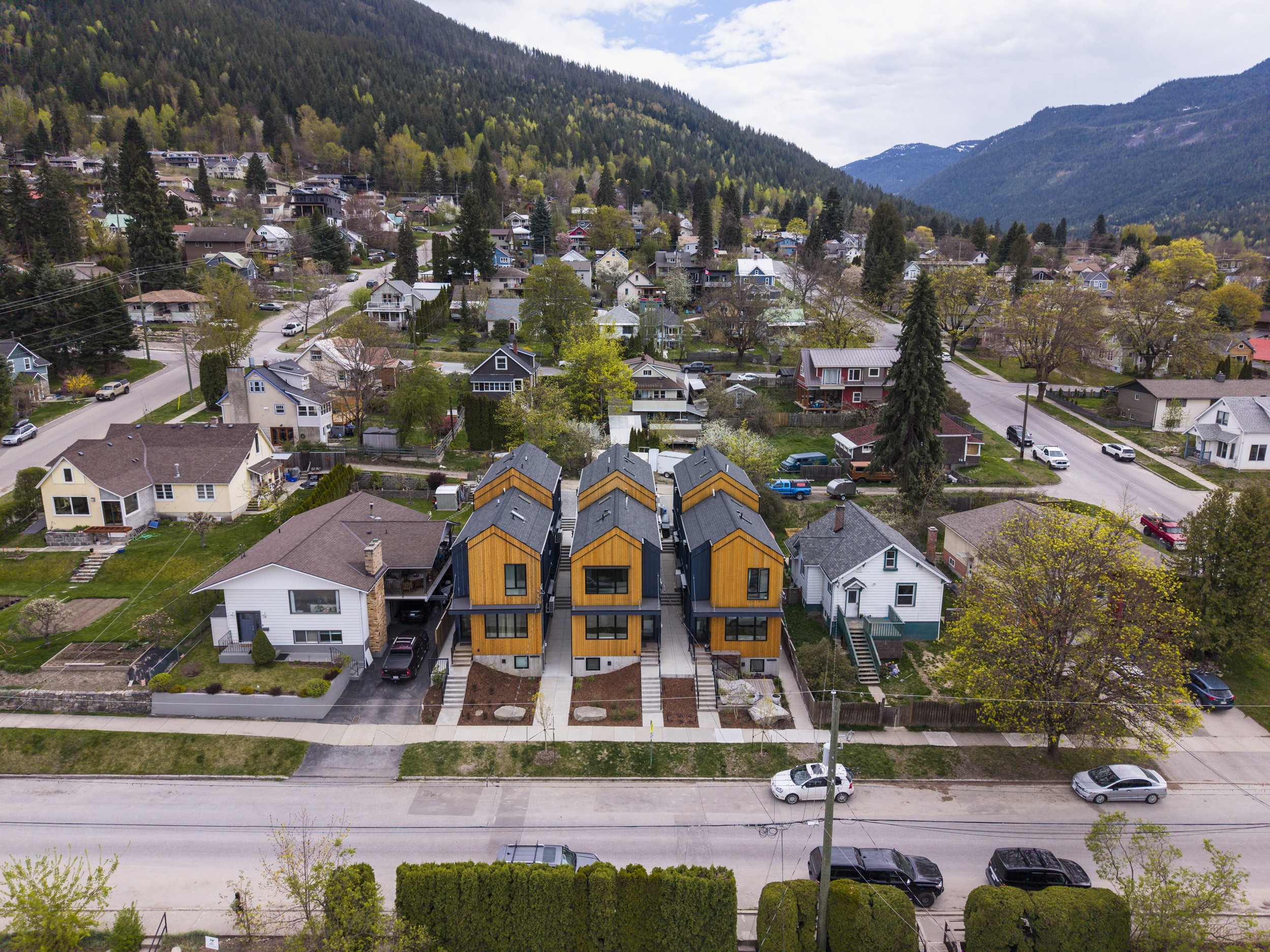 Aerial view of 518 B Robson Street in Nelson BC, a modern duplex in the Uphill neighbourhood with mountain views and surrounding residential homes.