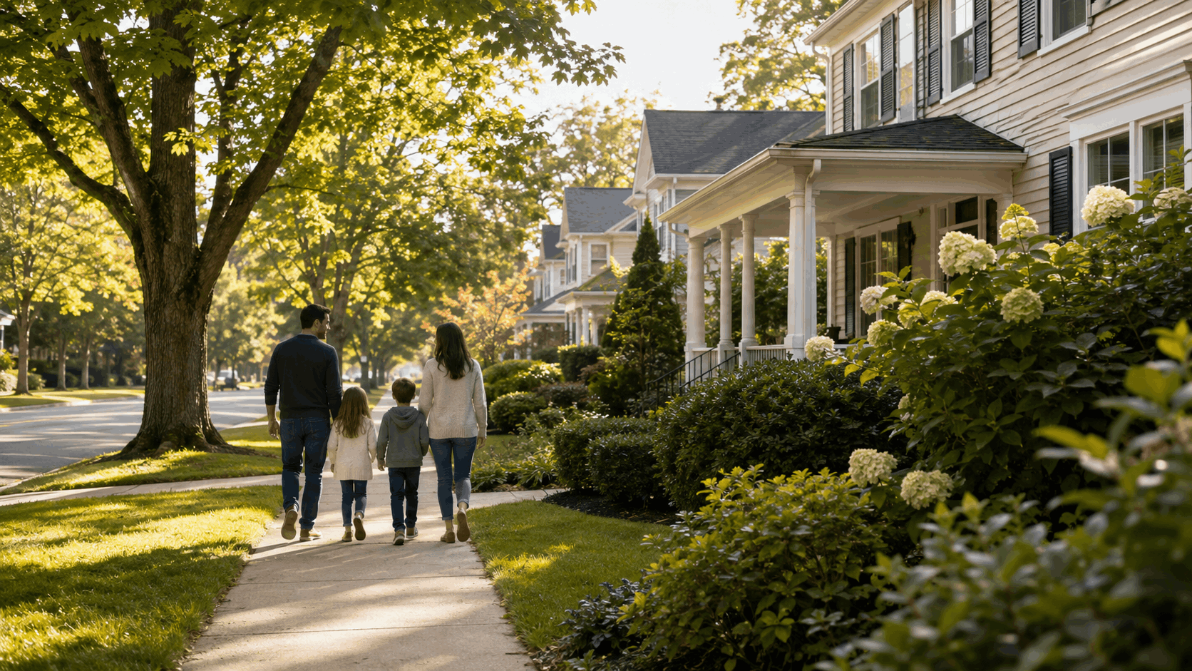 Family walking on a quiet Westfield NJ street with classic homes, mature trees, and sidewalks in warm morning light.