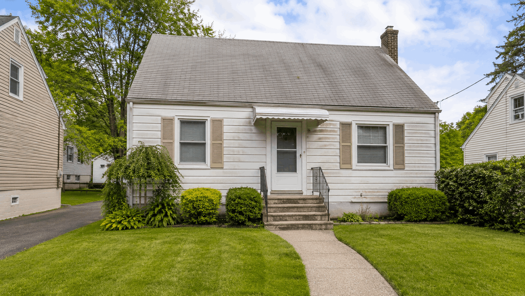 Older North Jersey home exterior prepared for an as-is probate sale with clean curb appeal.