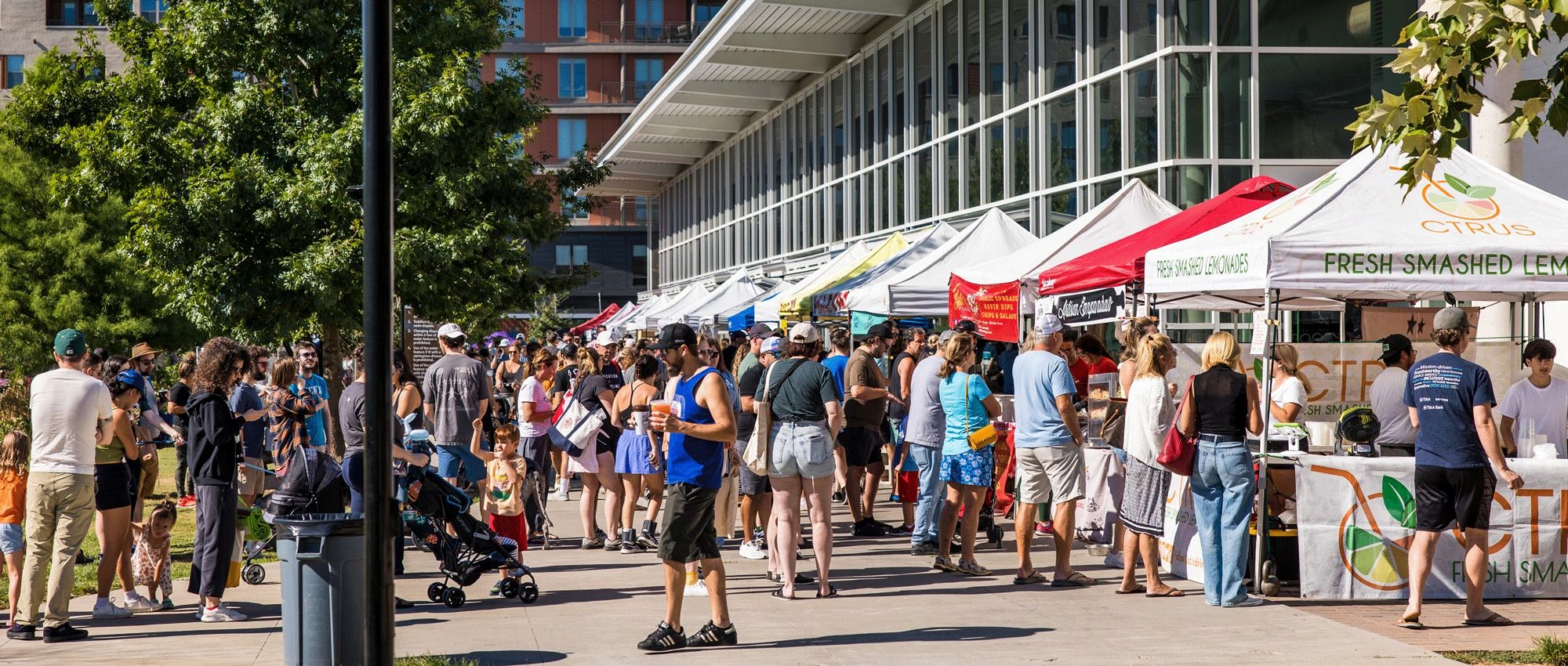 Outdoor farmers’ market with people shopping for produce in Austin