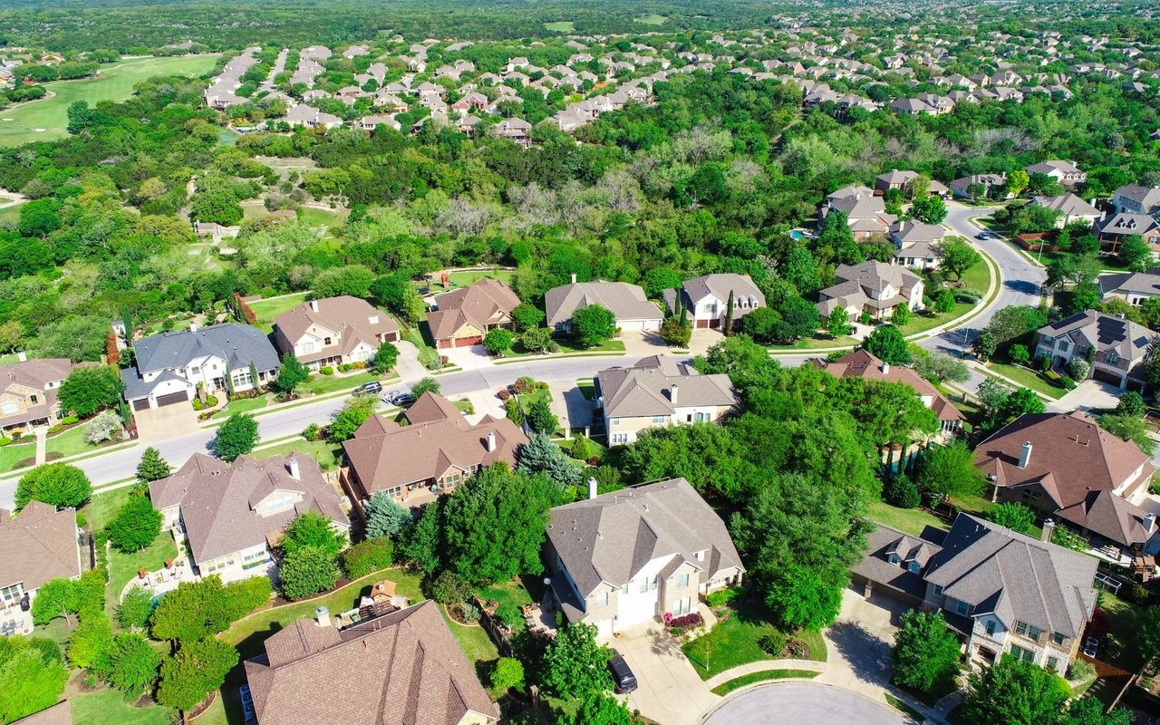 Aerial view showing suburban housing spread near a major city