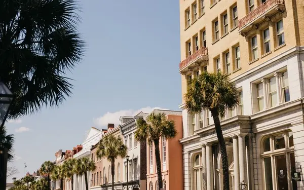 Historic street with palm trees and pastel buildings in Charleston, South Carolina