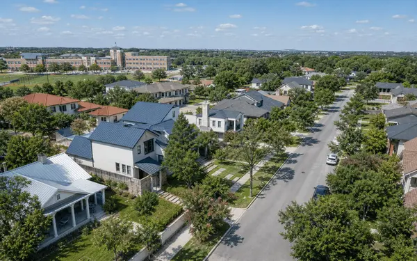 Elevated view of a San Antonio residential neighborhood with tree-lined streets and varied home styles