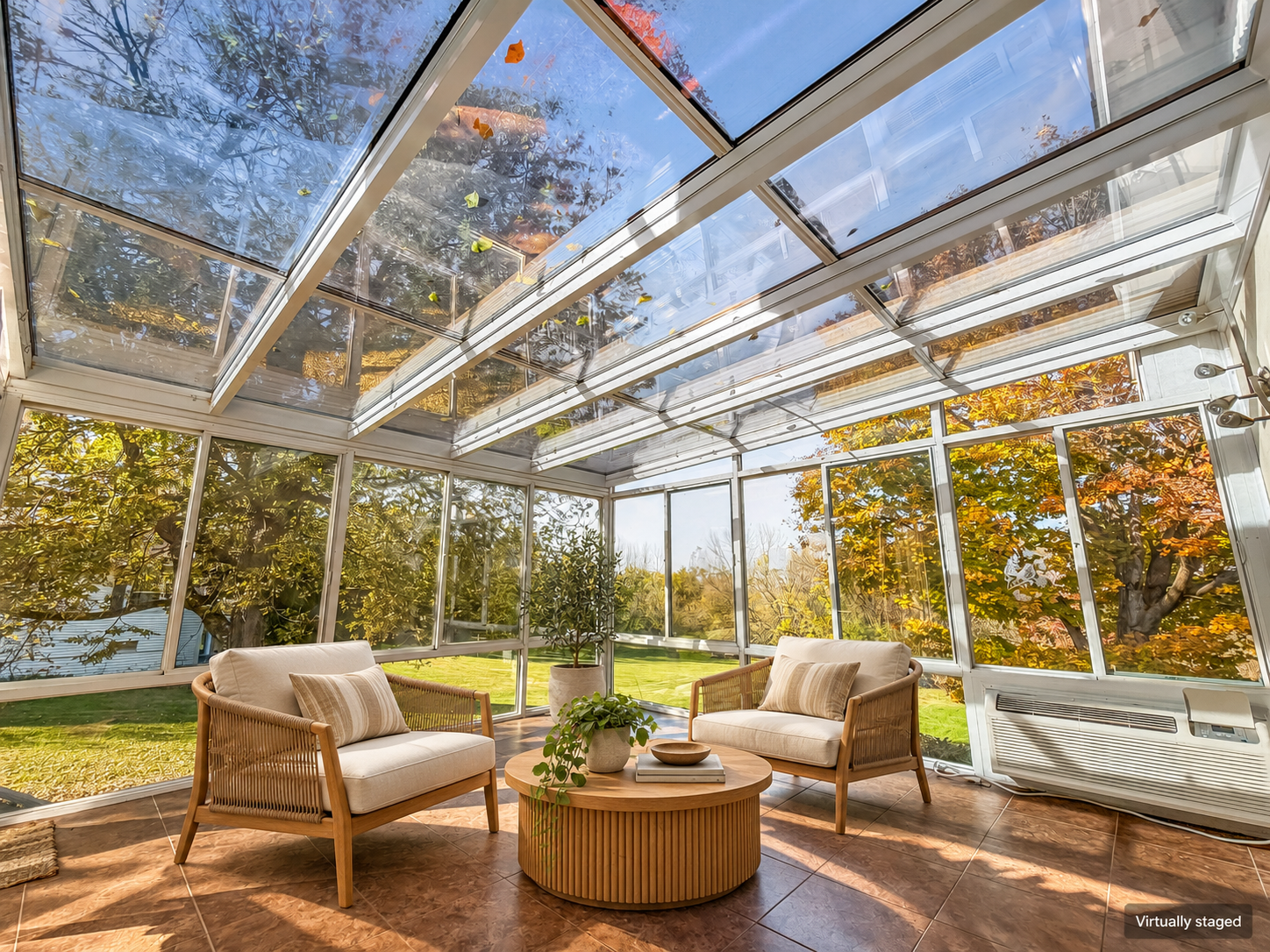 Glass-roofed sunroom with views of the back yard and trees, virtually staged