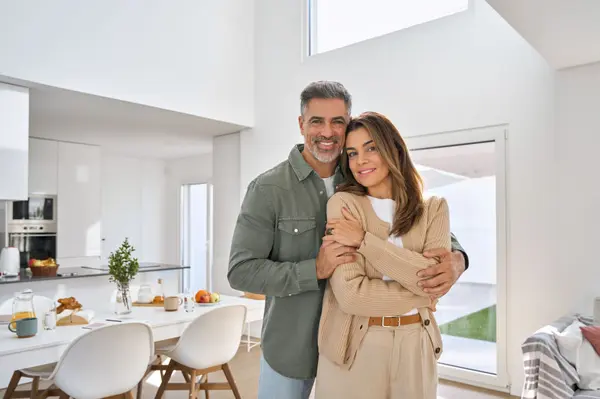 happy-middle-aged-mature-couple-hugging-standing-a-2025-02-11-16-23-55-utc (1)