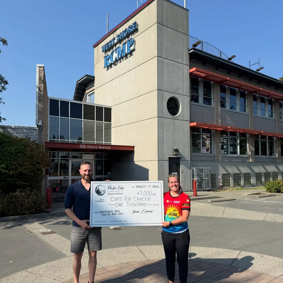 Presenting a $1,000 Cops for Cancer donation outside West Shore RCMP