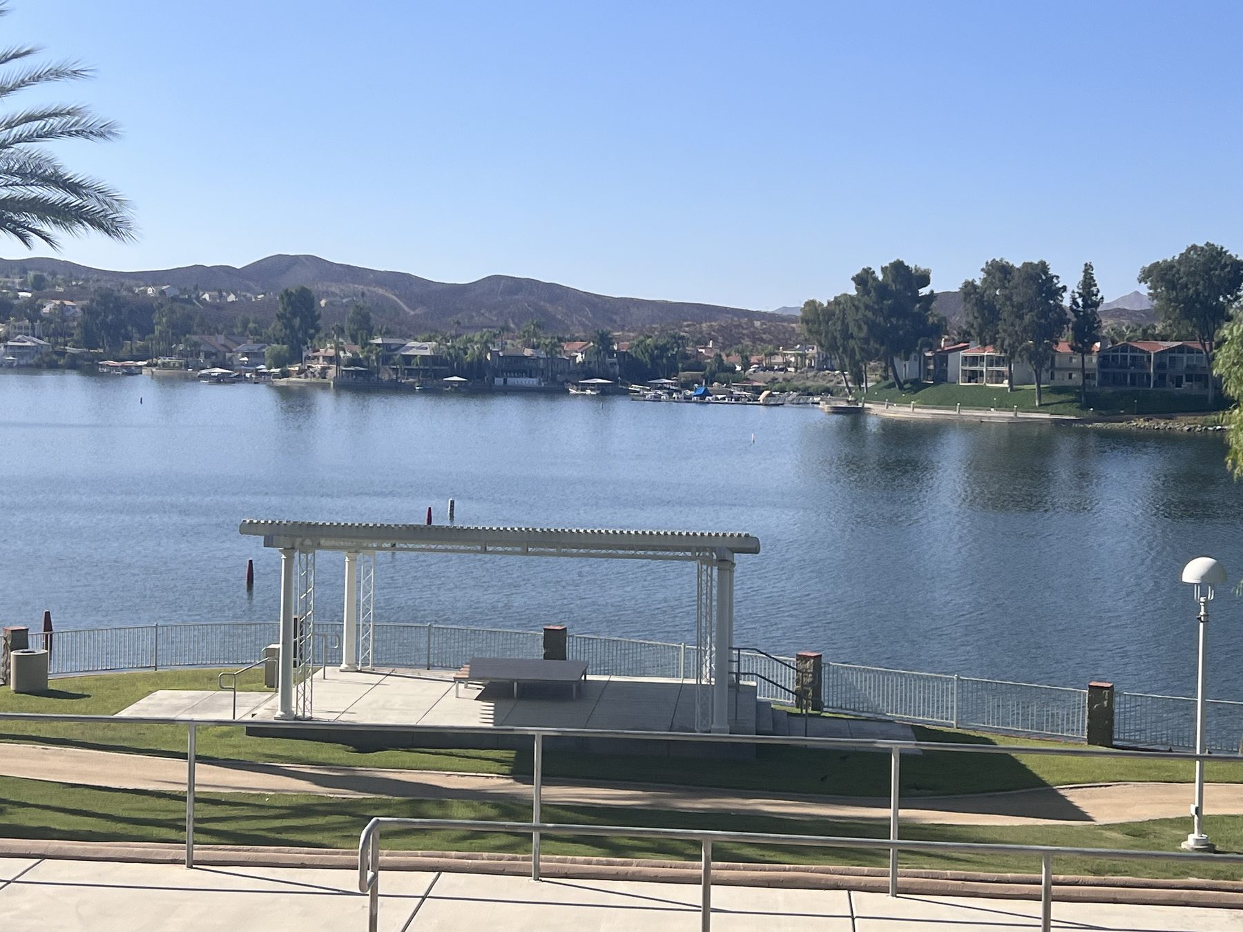 The main lake at Canyon Lake, California, with waterfront homes and hills along the far shore.