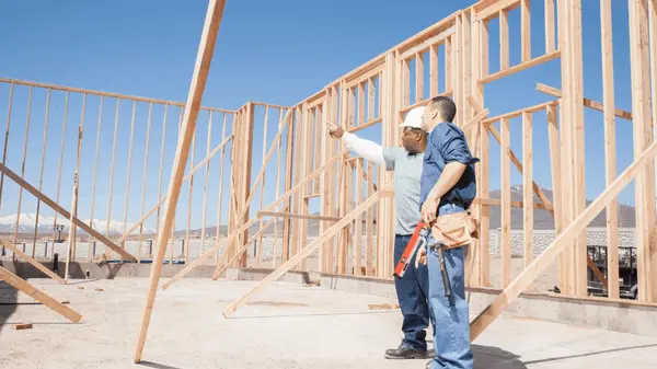 Construction workers talking about a new construction home