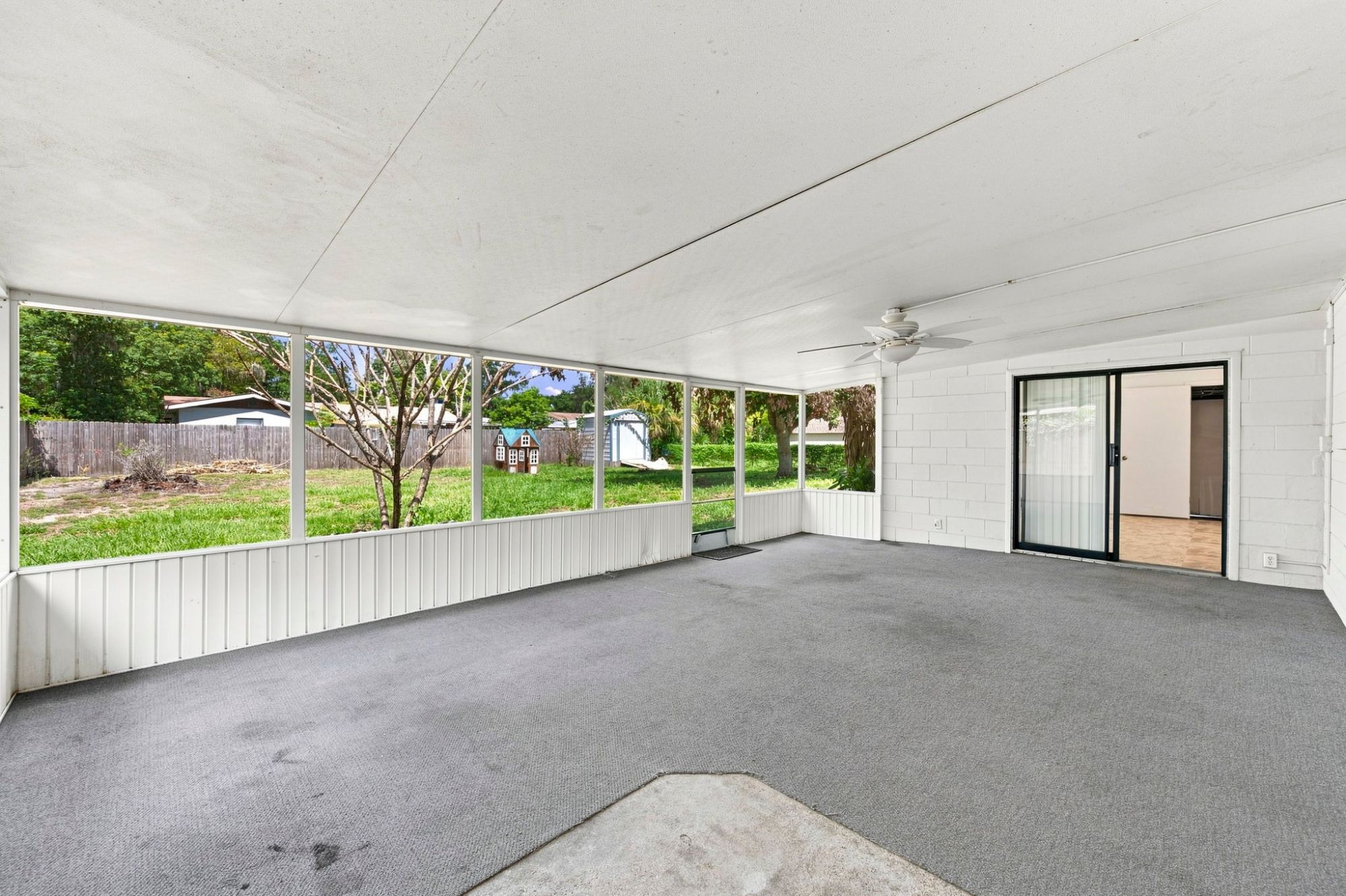 Large covered and screened porch at 1655 N Floral Ave in Bartow, Florida.
