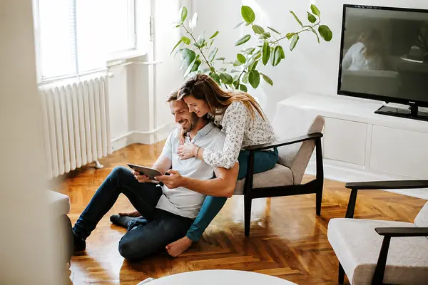 couple looking at computer searching for homes