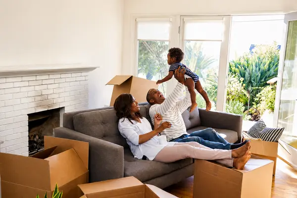 family with moving boxes surrounding them