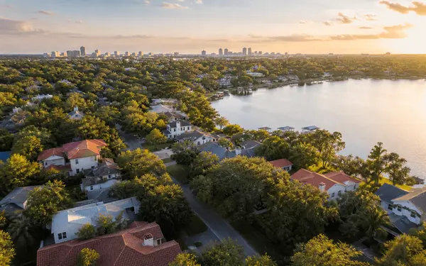 Aerial view of a leafy Central Florida lakeside neighborhood at golden hour