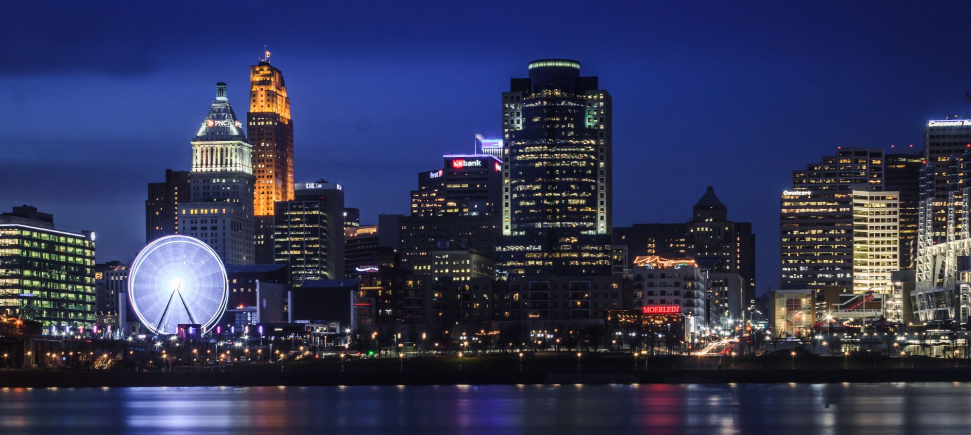 Cincinnati skyline illuminated at blue hour across the Ohio River