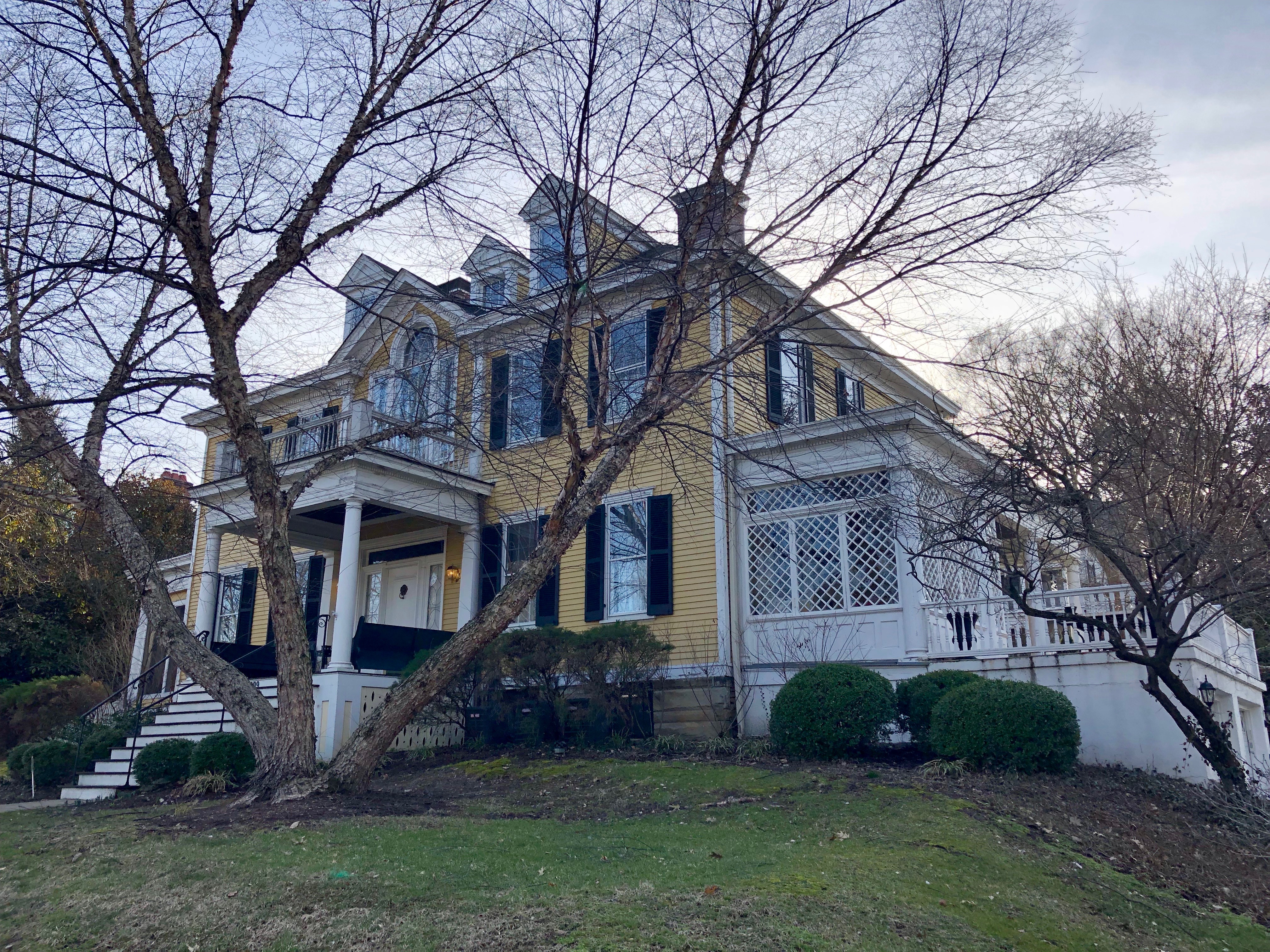 Historic home with a broad porch and detailed roofline on Annwood Street in East Walnut Hills