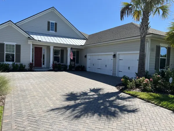 Coastal-style home with a paver driveway in St. Johns County