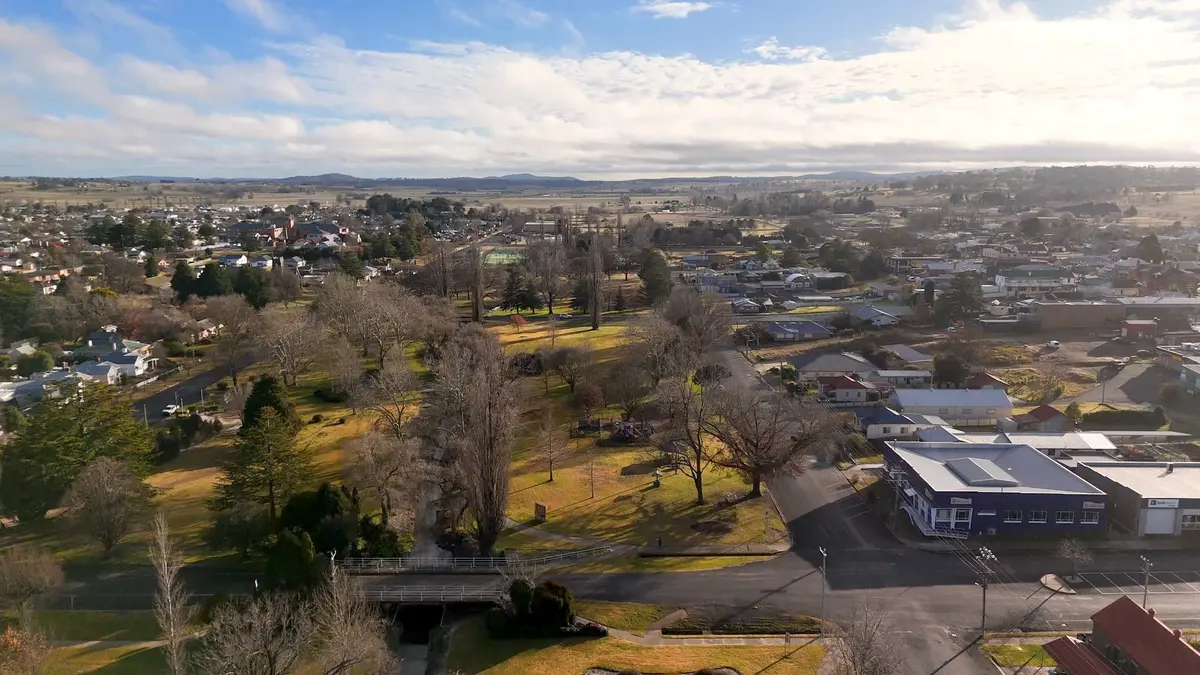 aerial-view-rural-town-with-houses-trees-cloudy-sky
