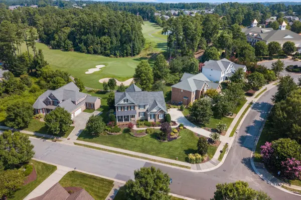 Aerial view of a suburban neighborhood and green space