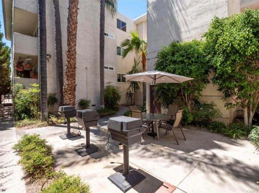 Barbecue grills and patio table in the courtyard at 5412 Lindley Avenue, Encino