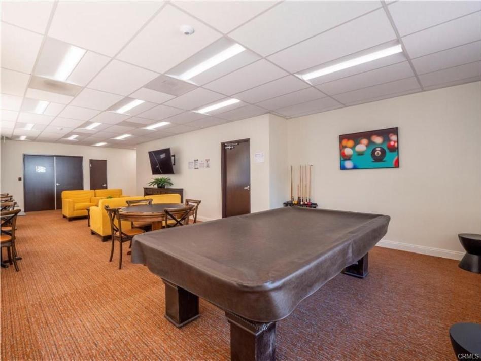 Encino Villas recreation room with a billiard table, card table and lounge chairs