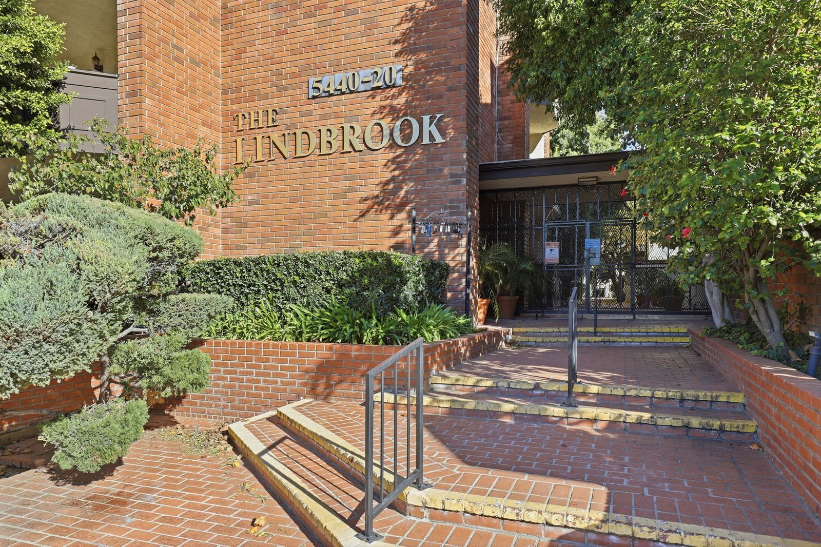 Main entrance of The Lindbrook condominium community at 5420–5440 Lindley Avenue in Encino, California