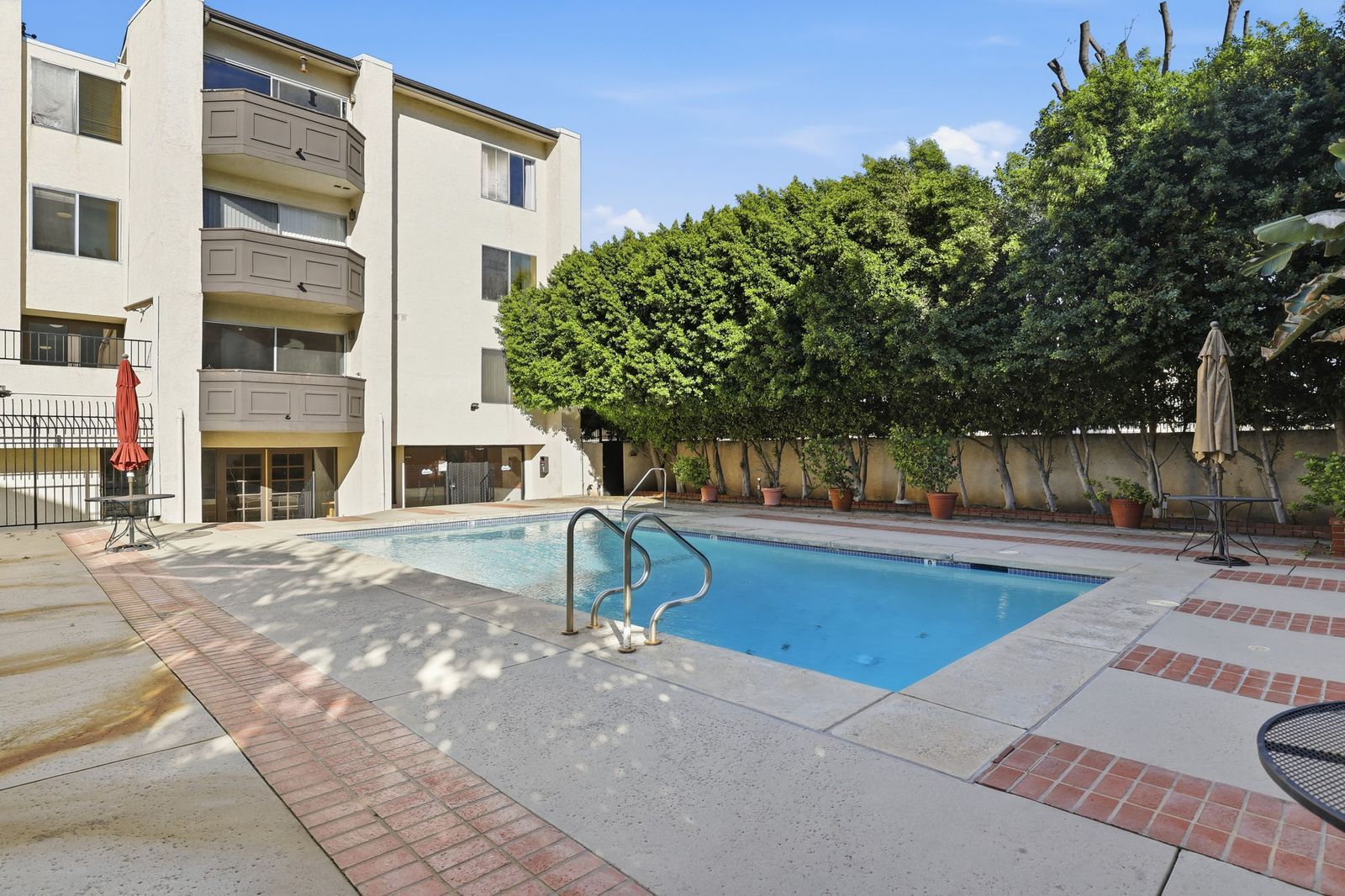 Community pool at The Lindbrook in Encino, with the 5440 Lindley Avenue condominium building behind it