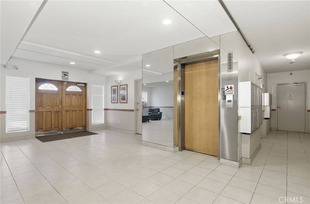 Ports of Call lobby at 5400 Lindley Ave with elevator and entry doors