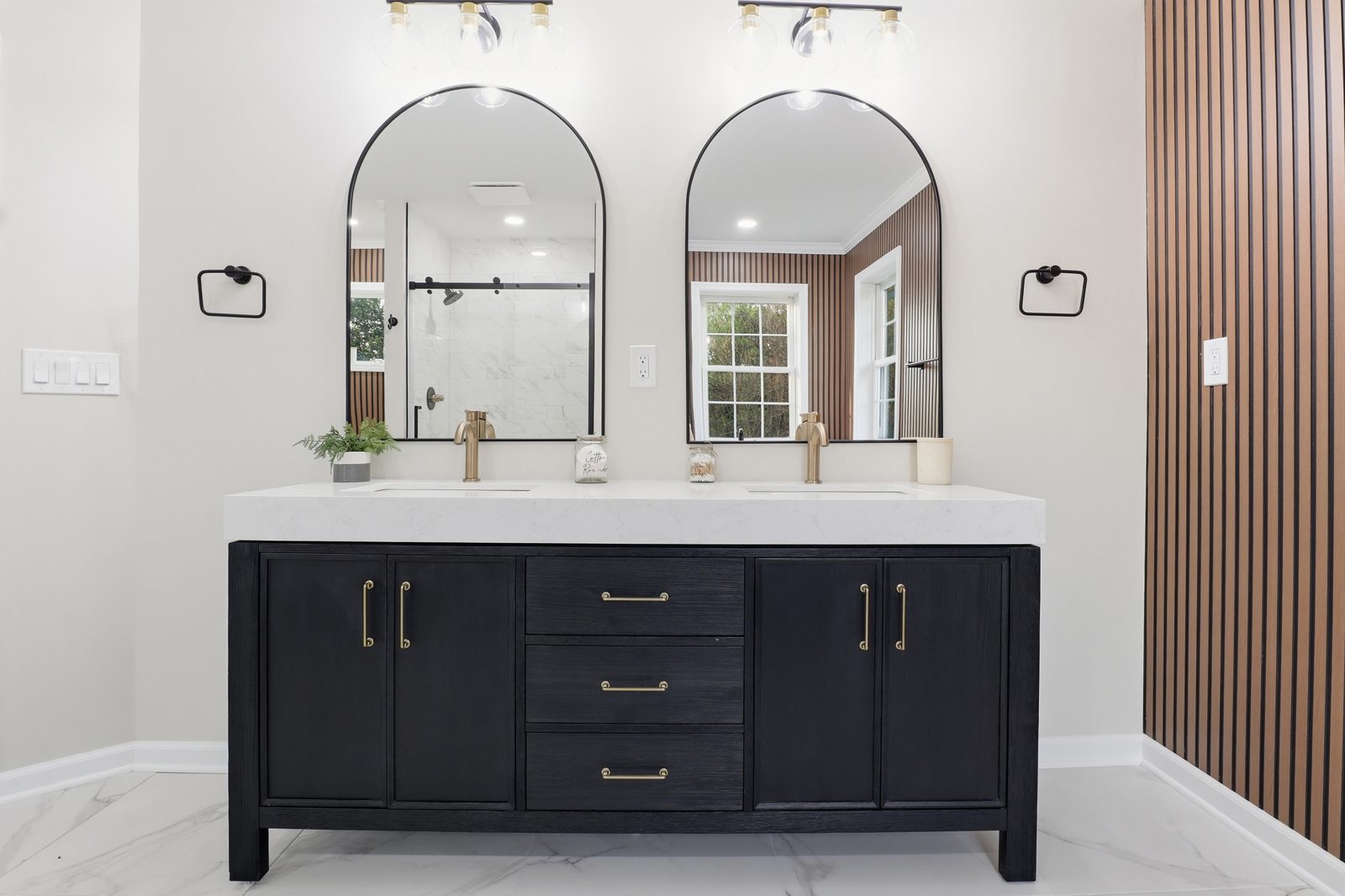 Renovated primary bathroom with double vanity and arched mirrors, prepared for sale in York County PA