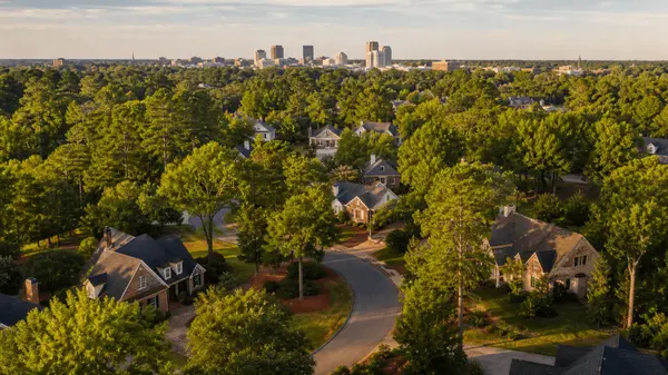 Aerial view of a Northeast Columbia South Carolina neighborhood at golden hour with the Columbia skyline beyond