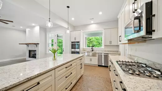 Kitchen with soft close drawers and spice rack drawers.