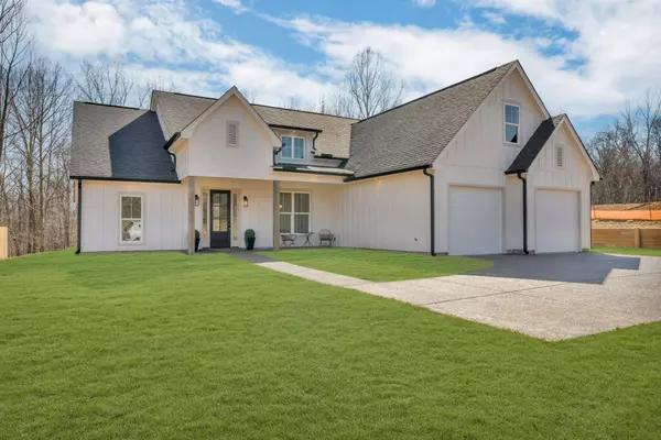 Front Exterior: Beautiful new construction farmhouse-style home with a charming front porch and modern finishes.