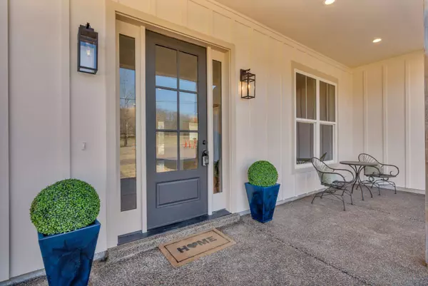 Front Exterior: Beautiful new construction farmhouse-style home with a charming front porch and modern finishes.