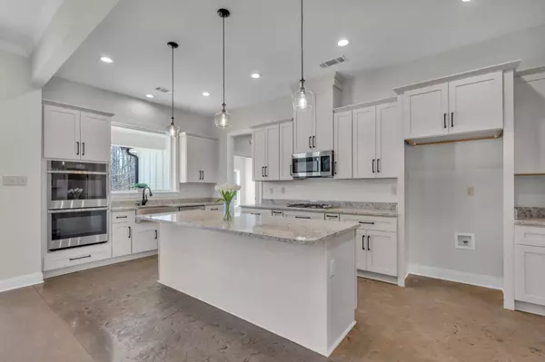 Kitchen & Dining: Stunning kitchen with sleek countertops, modern cabinetry, and an island overlooking the dining area.