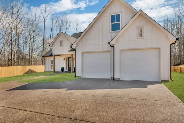 Front Exterior: Beautiful new construction farmhouse-style home with a charming front porch and modern finishes.