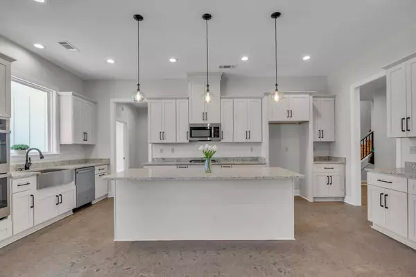 Kitchen & Dining: Stunning kitchen with sleek countertops, modern cabinetry, and an island overlooking the living area.