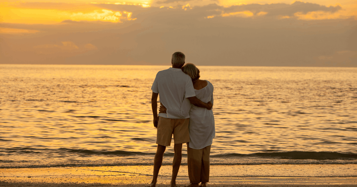 Retired couple reflecting on their future plans while walking on a Hawaii beach
