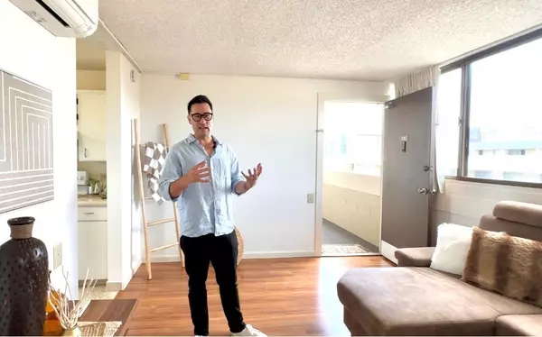 Real estate advisor Dylan Fujimoto showing a home to buyers in Kaneohe, Hawaii.