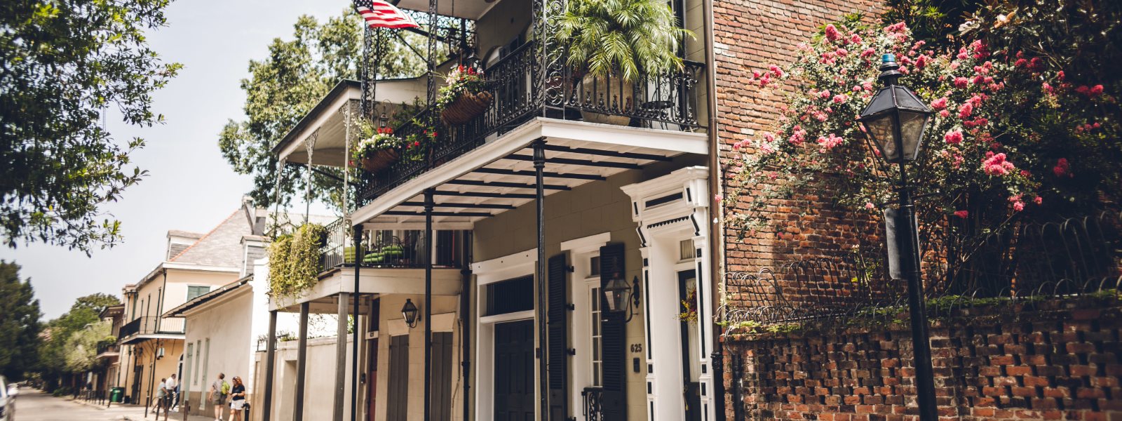 Historic French Quarter street in New Orleans with wrought-iron balconies and flowering plants