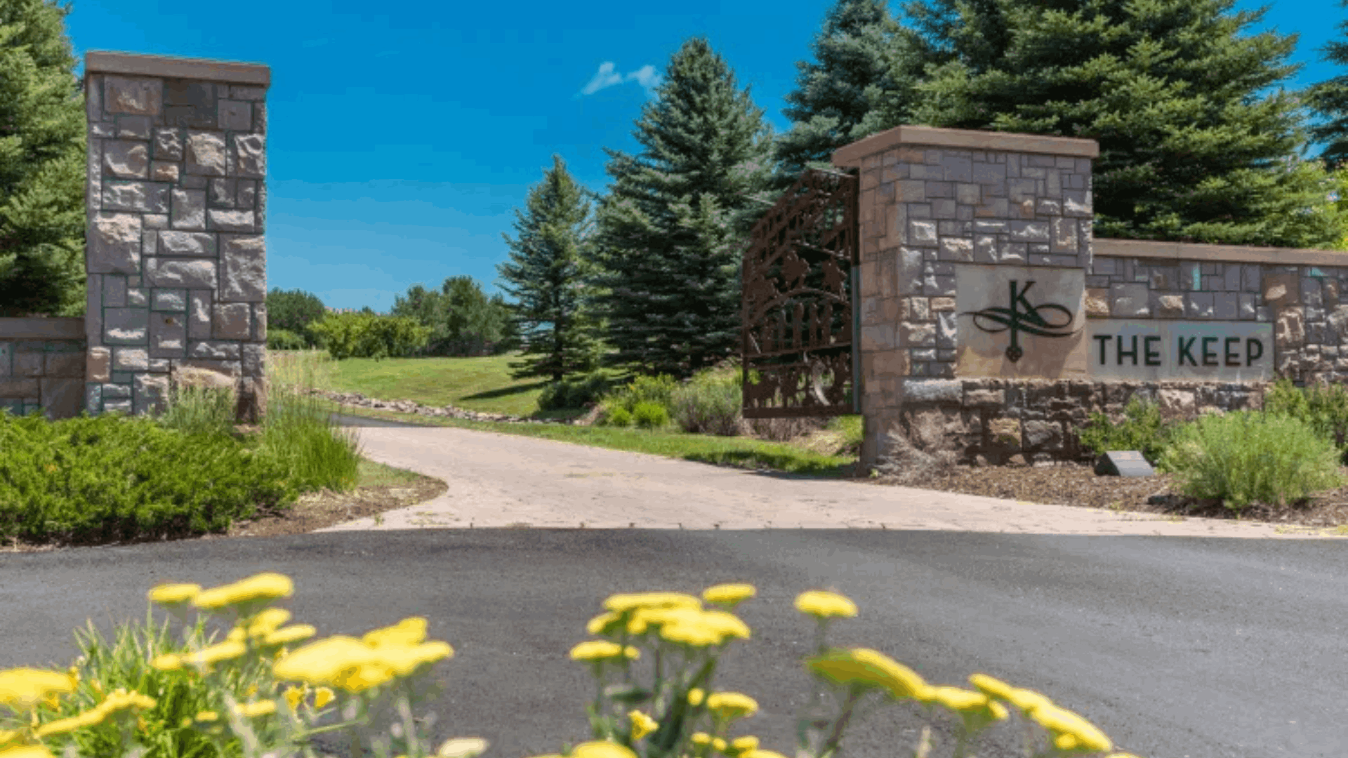 &ldquo;Entrance gate to The Keep luxury land community in Sedalia, Colorado surrounded by trees and landscaped greenery&rdquo;