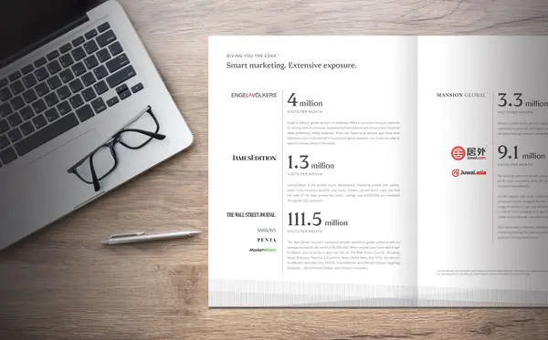 An Edge brochure opened on a desk next to a laptop, eyeglasses, and pen