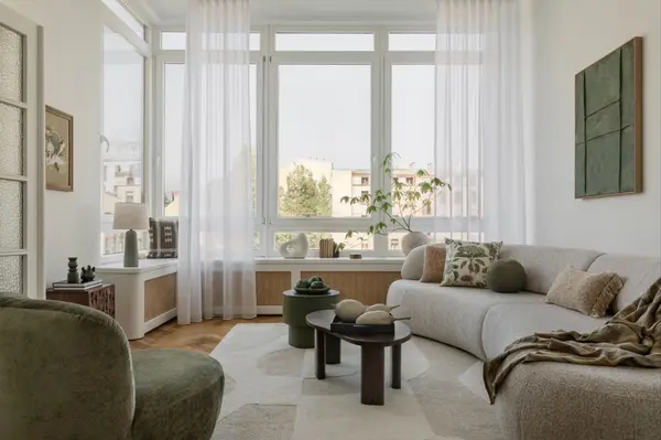 Bright, cozy living room with natural light, lush plants