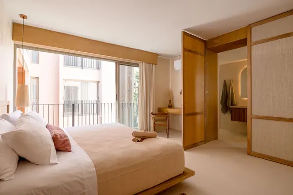 Serene bedroom with natural materials at Aflora Tulum luxury residences
