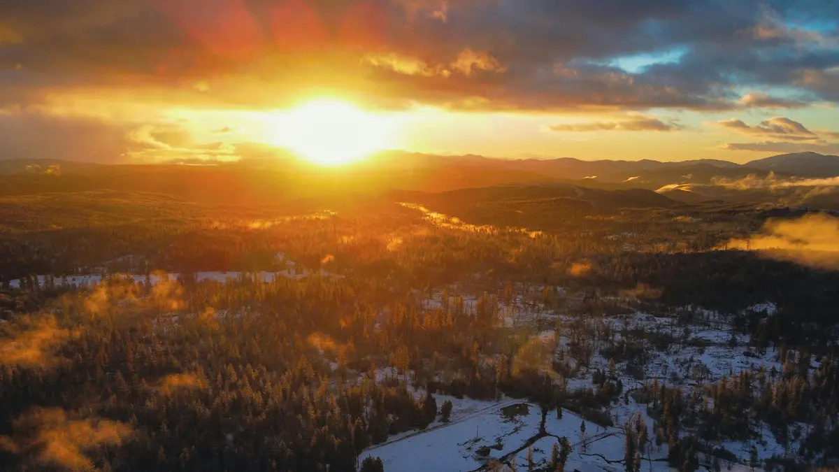 orange sunset mountain scene with snow