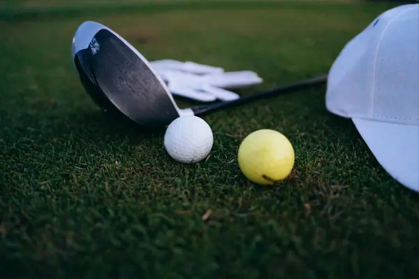 yellow and white golf call with gold club and hat