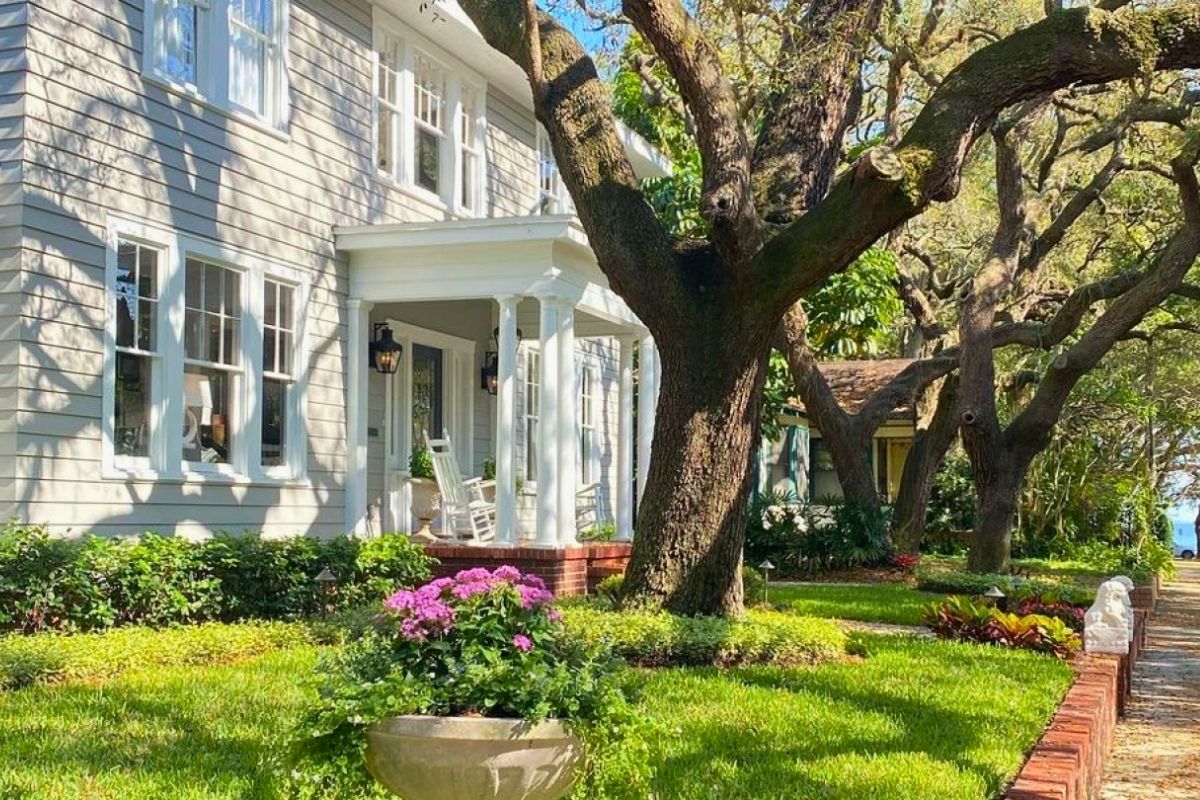 Historic Hyde Park home in South Tampa with front porch rocking chairs oak tree and waterfront view 2026