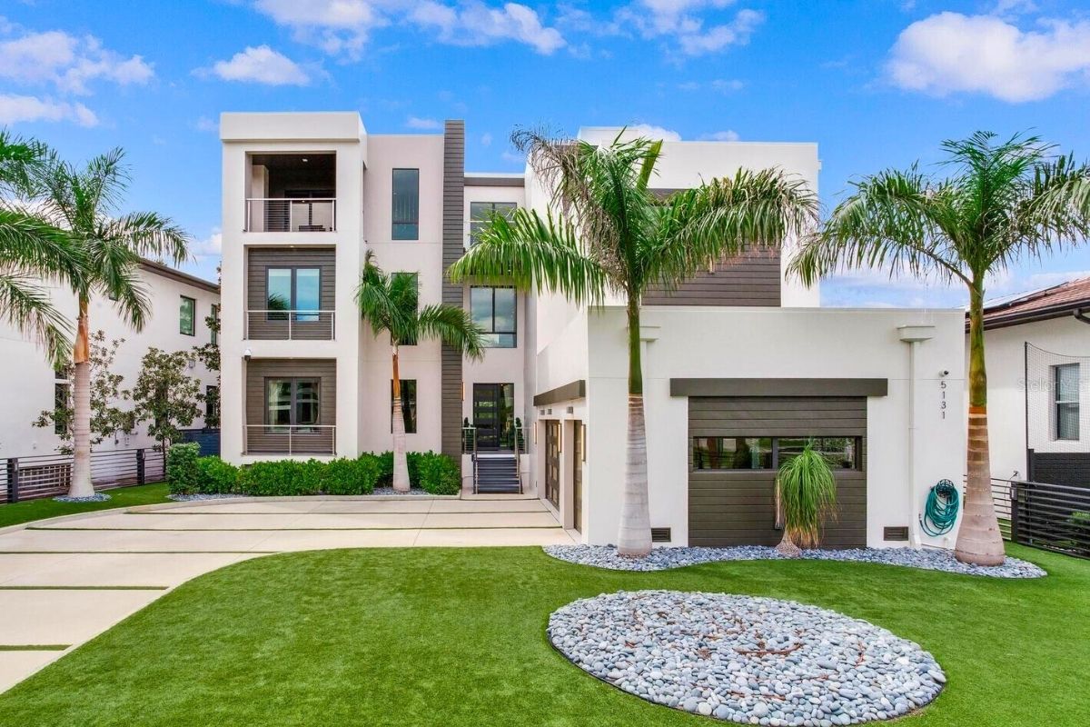 Modern new construction luxury home in Beach Park South Tampa with palm trees and three car garage 2026