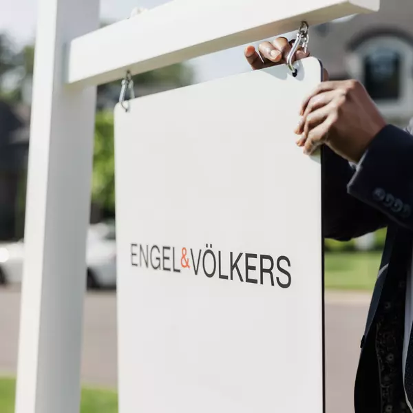 Engel & Volkers For Sale sign being put up in yard