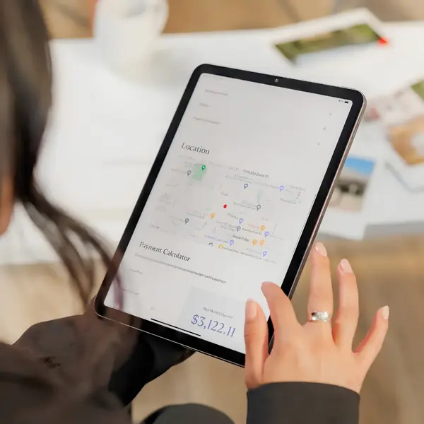 Kirby Drake, Real Estate Advisor, reviewing property location data and payment analysis on a tablet - St. Petersburg home selling consultation