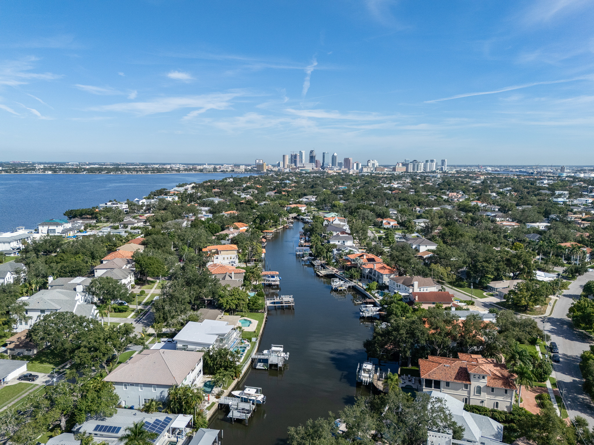 Aerial view of a Davis Islands residential canal in Tampa, showing waterfront homes, private docks, seawalls and lot configurations.